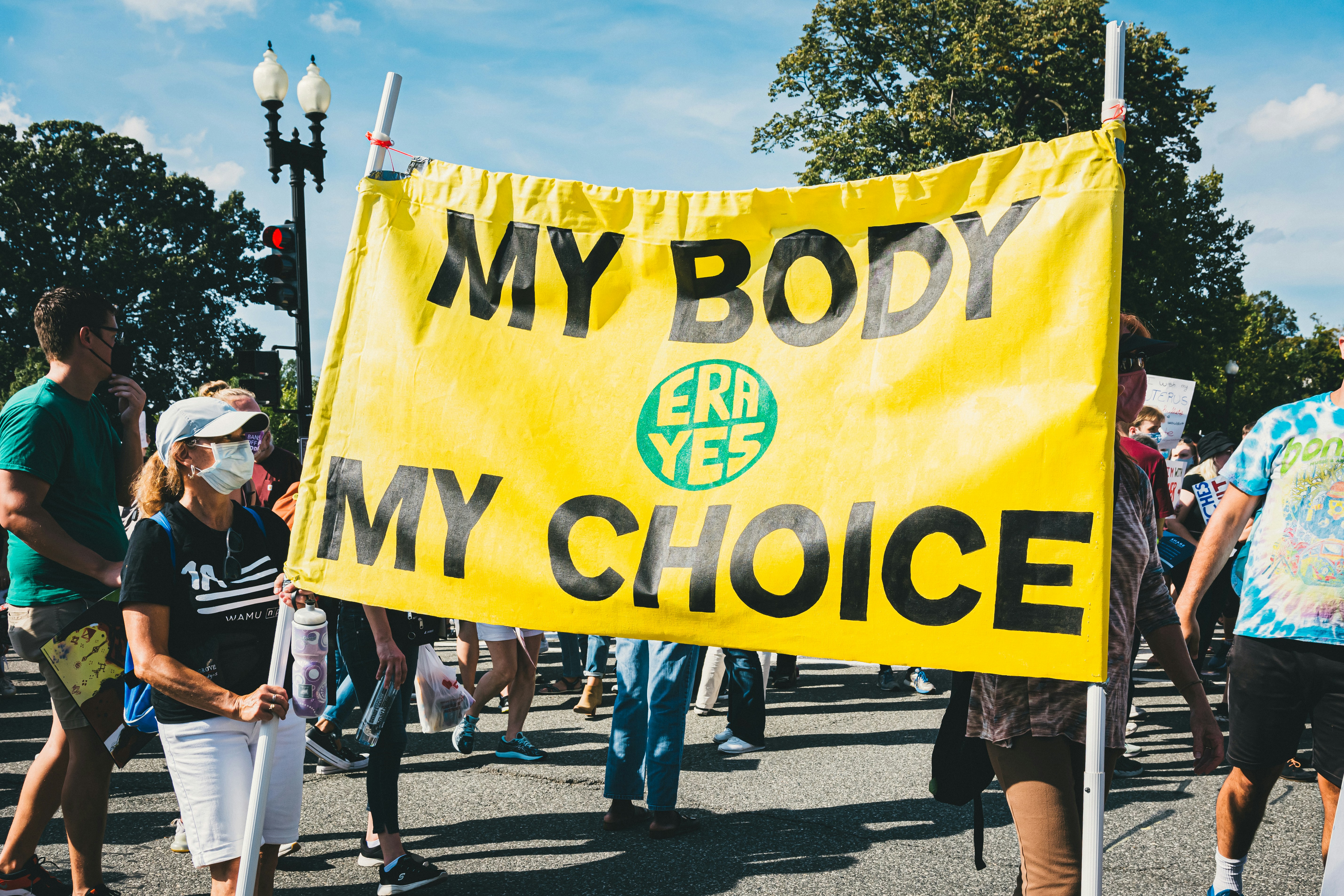 People marching for reproductive rights with My Body My Choice sign